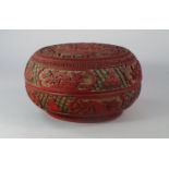 A Chinese cinnabar lacquer box, 19th century, the top of domed form carved with a central panel of a