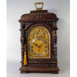 A large oak mantel clock, late 19th/early 20th century, probably German, with a large brass carrying