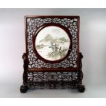 A Chinese hard wood table screen, Republican, the square screen with pierced trelliswork, inset with