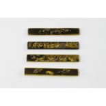 Four shakudo knife handles, kozuka, Goto School, Edo Period, moulded with friezes of chrysanthemums,