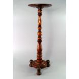 A yew wood candle stand, 19th century, with ball and baluster turned stem, on circular base with