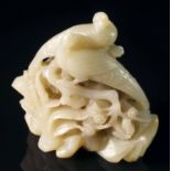 A Chinese pale green jade carving, early 20th century, depicting two magpies perched on blossoming