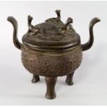 A Chinese bronze tripod censor and cover, 19th century, archaistic style with twin curved handles,