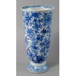 A Chinese porcelain vase, 19th century, with fluted body painted in underglaze blue with lotus