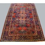 A Bakhtiari rug with oval pole medallion surrounded by a garden parterre design and border,