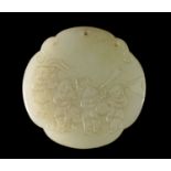 A Chinese pale green jade quatrilobed pendant, carved to one side with four boys in a procession and