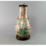 A Cantonese vase, 19th century, with lions mask handles, painted with scenes of courtiers in