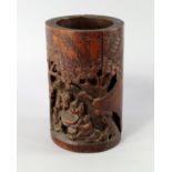 A Chinese bamboo brush pot, early 20th century, carved with figures playing wei qi beneath pine