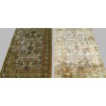 A near pair of Qum silk rugs each with eight medallions in the ivory field and with flowerhead
