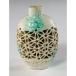 A Chinese porcelain reticulated snuff bottle, late 19th century, with cream glaze splashed with