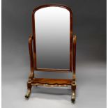 A Victorian mahogany cheval mirror with arched plate, circa 1880,