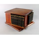 An Edwardian mahogany and inlaid desk swivelling bookcase, on square base with bevelled corners,