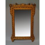 A French giltwood mirror, 18th century, with scrolling pierced top rail, the four corners with