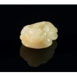 A Chinese jade model of a toad, 20th century, squatting on a rock, 4.5cm long CONDITION REPORT: good