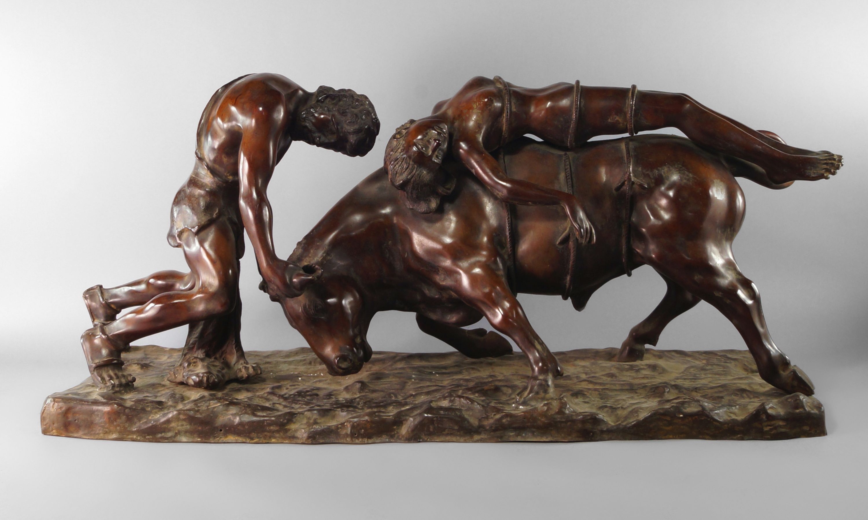 A large bronze model Europa and the bull, 20th century, the bull being wrestled by a man, on a