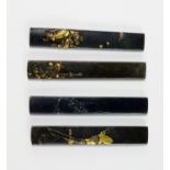 Four shakudo knife handles, kozuka,  Edo Period, three applied with figures of warriors,