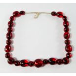 A cherry amber coloured graduated bead necklace, 20th century,