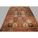 A Bakhtiari carpet of polychromatic garden design with red main border,