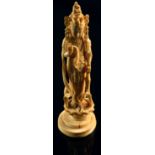 A Japanese Meiji period ivory okimono of Kannon (Guanyin), modelled standing on a lotus throne