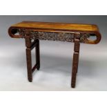 A Chinese hardwood scroll table, early 20th century, with profusely carved and pierced frieze on