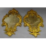 A pair of mid 19th century Rococo revival wall mirrors with scrolled foliate and floral decorated