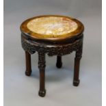 A Chinese rosewood occasional table, 19th century, with rouge marble inset circular top above carved