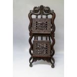 A Chinese carved hardwood two tier magazine rack, early 20th century,