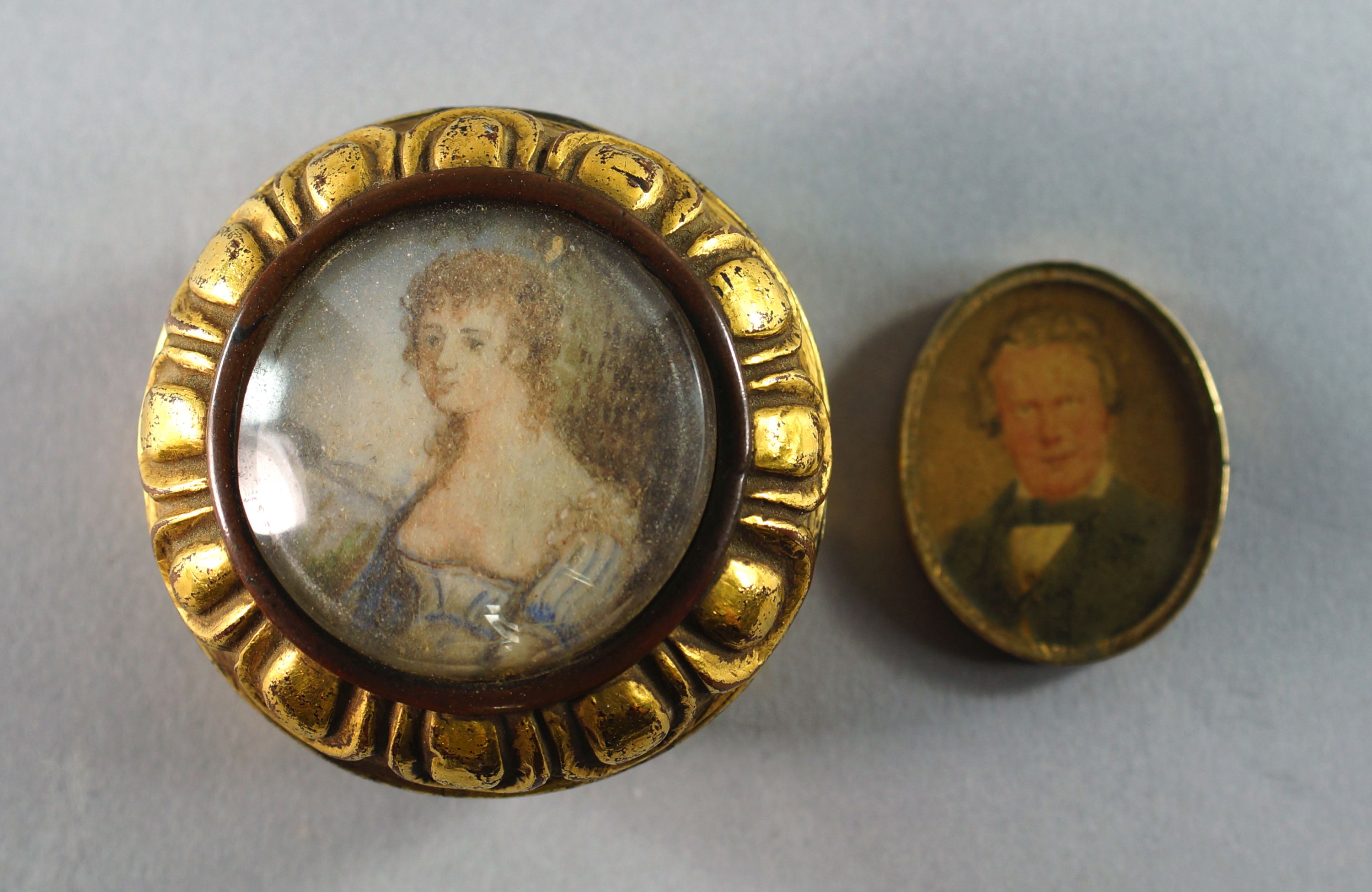 A circular gilt bronze box, 19th century, with lobed moulding, inset with a portrait of a young girl