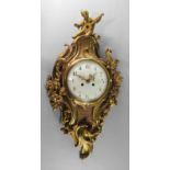 A French ormolu cartel clock, late 19th/early 20th century, the top mounted with a cherub in the