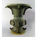 A Chinese bronze archaistic vase, zun, 19th century, the main body set with floral bosses,