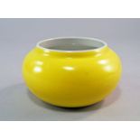 A Chinese porcelain monochrome wei qi bowl, Republic Period, with pale yellow glaze, squat body