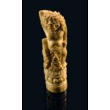 A Burmese carved bone kris handle, 19th century, carved as a mythical Buddhist beast, 12.5cm high.