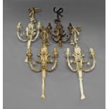 A set of four painted gesso and wire-work three light wall sconces,