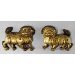 A rare pair of Tibetan copper-gilt repousse Buddhist lion temple gate mounts, 17th century,