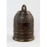 A Chinese bronze temple bell, with ribbed body and cast with panels of stars, 16cm high.   CONDITION