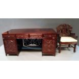 A large Chinese stained hardwood pedestal desk, 20th century, with four frieze drawers above two