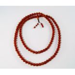 A long amber coloured bead necklace, 20th century,