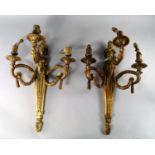 A pair of French gilt bronze three light wall appliques, late 18th/ early 19th century, with flaming
