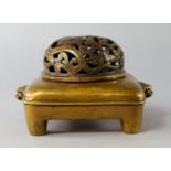 A Chinese bronze censer, 19th/20th century, moulded with lion handles, on cylindrical feet, marks to