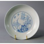 A Chinese blue and white saucer dish, painted to the centre with a  circular panel of chrysanthemums