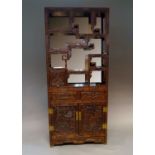 A Chinese hardwood two section cabinet, 20th century, the etagere top section with mirrored back and