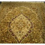 A Turkish green rug, with central shaped lozenge, on olive and floral ground,