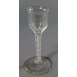 An English drinking glass, 18th century, the rectangular shaped bowl on tall stem with ribbon and