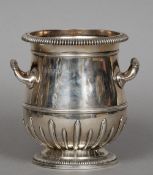 A silver half bottle wine cooler, hallmarked London 1912, maker's mark of D & J Welby Limited
Of