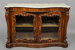 A Victorian marble topped rosewood side cabinet
Of serpentine form with twin C-scroll framed