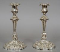 A pair of Victorian silver candlesticks, one hallmarked Sheffield 1838, the other Sheffield 1841,