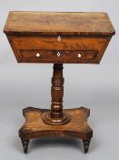 A 19th century mahogany work table
The crossbanded hinged rectangular top above a fitted frieze