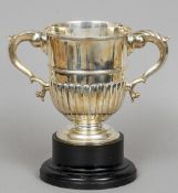 A Victorian twin handled silver trophy cup, hallmarked London 1890, maker's mark of John Harry