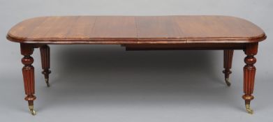 A Victorian mahogany extending dining table
The rounded rectangular top incorporating two additional