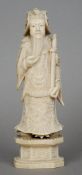 A Chinese carved ivory figure of a dignitary 
Modelled wearing ornately carved robes and holding a